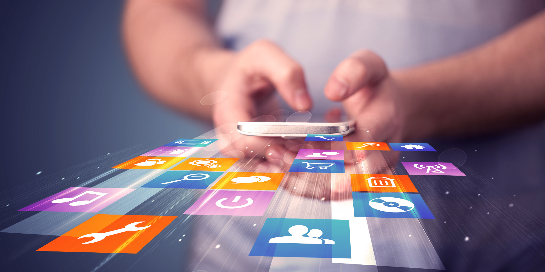 App Store Man holding smart phone with colorful application icons comming out