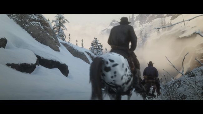 Zwei Personen reiten durch tiefen Schnee in den Bergen.