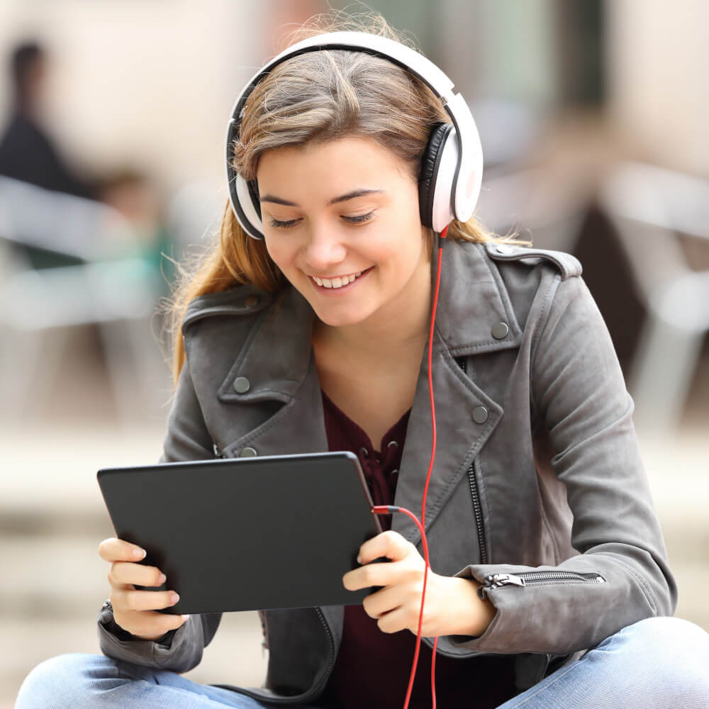 Junge Frau schaut auf ihrem Tablet ein Video