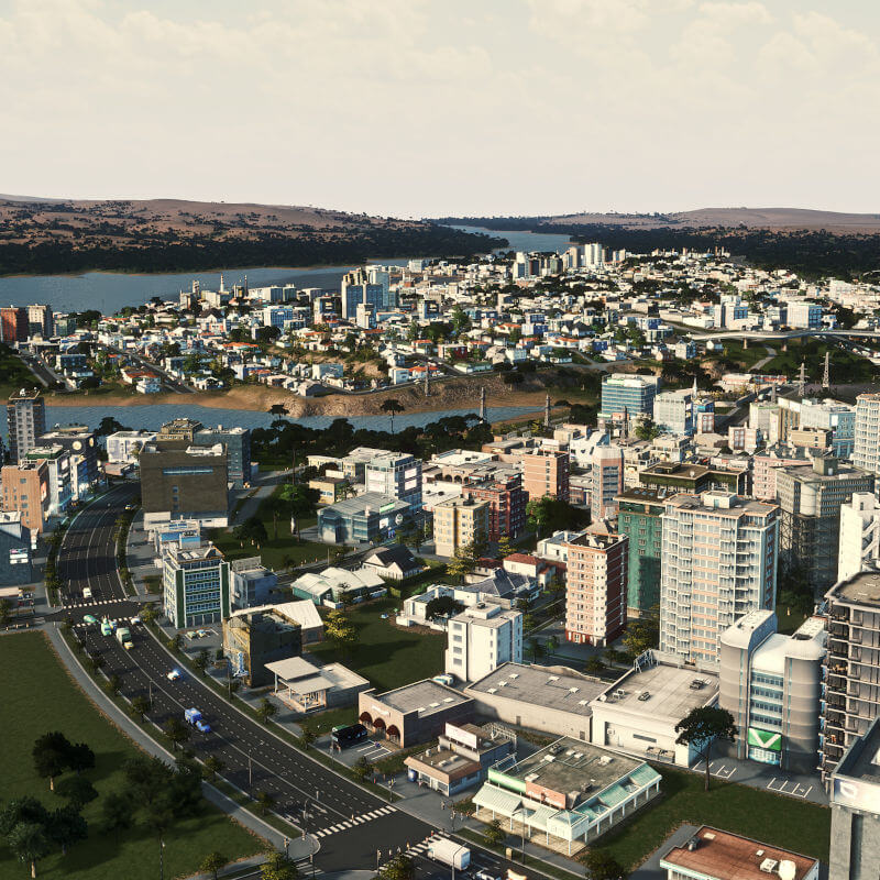 Eine kleine Stadt in Cities Skylines, am fruchtbaren Flussufer einer sonst eher kargen Landschaft.